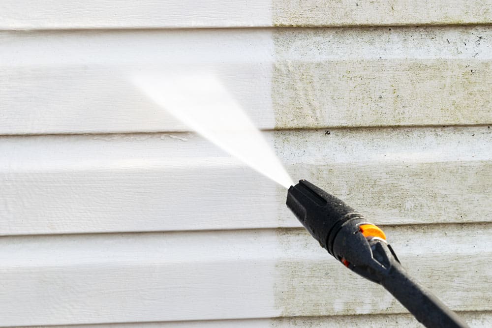 Side panels on a home, with one side white and spotless while the other side is brown and dirty