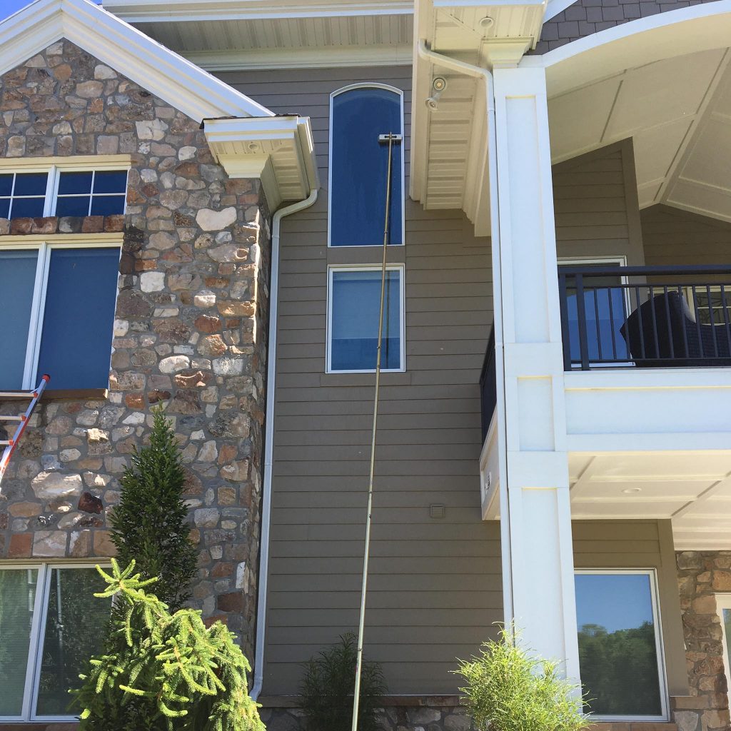 Using a deionized water-fed pole to clean a very high window