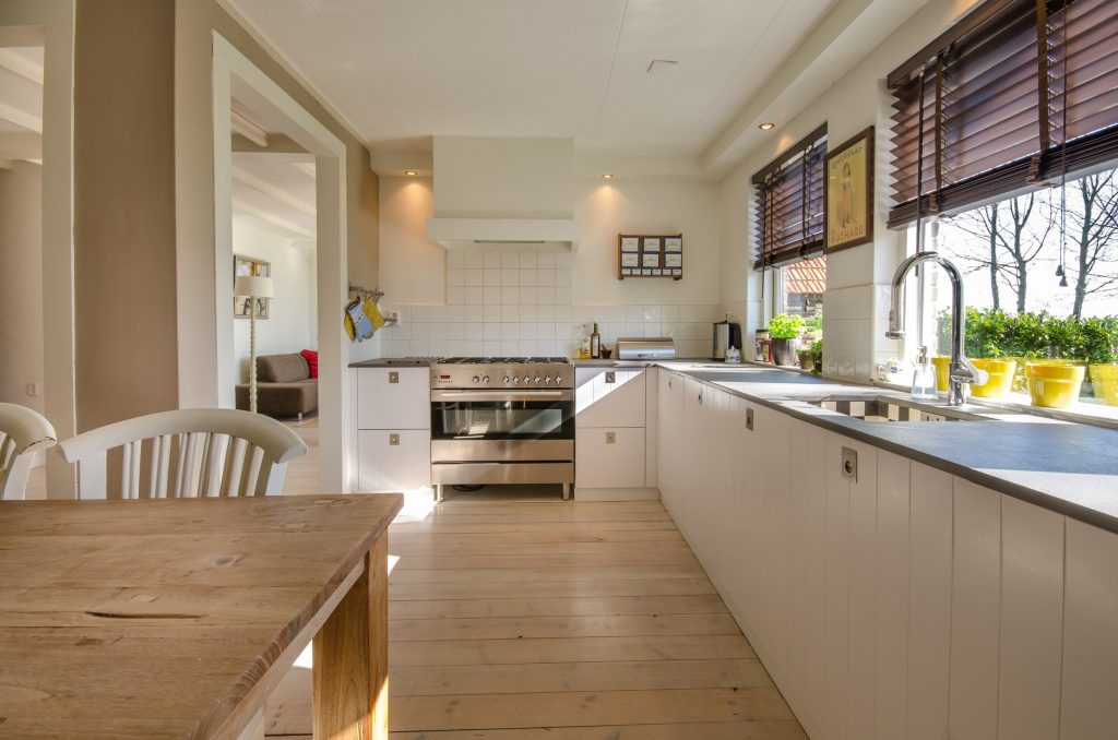 A snapshot of the interior of a kitchen with tons of bright sunlight shining through the windows