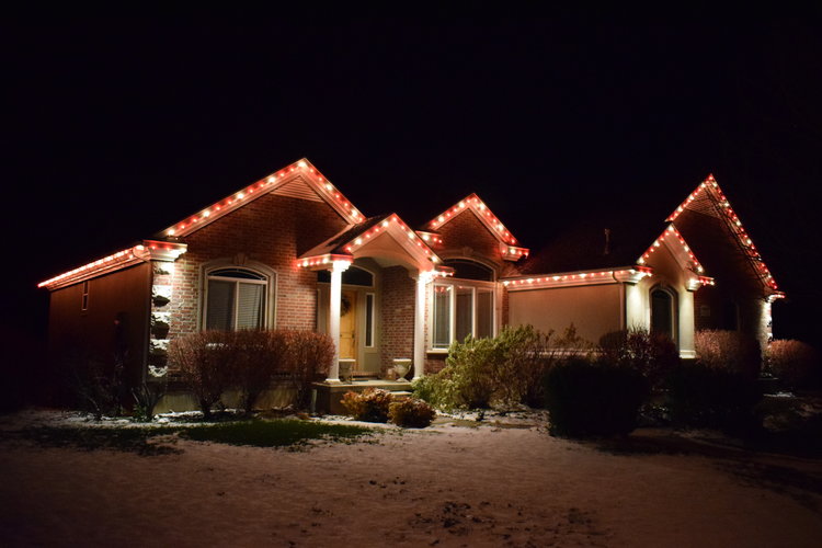 A snowy home beautifully decorated for the holidays