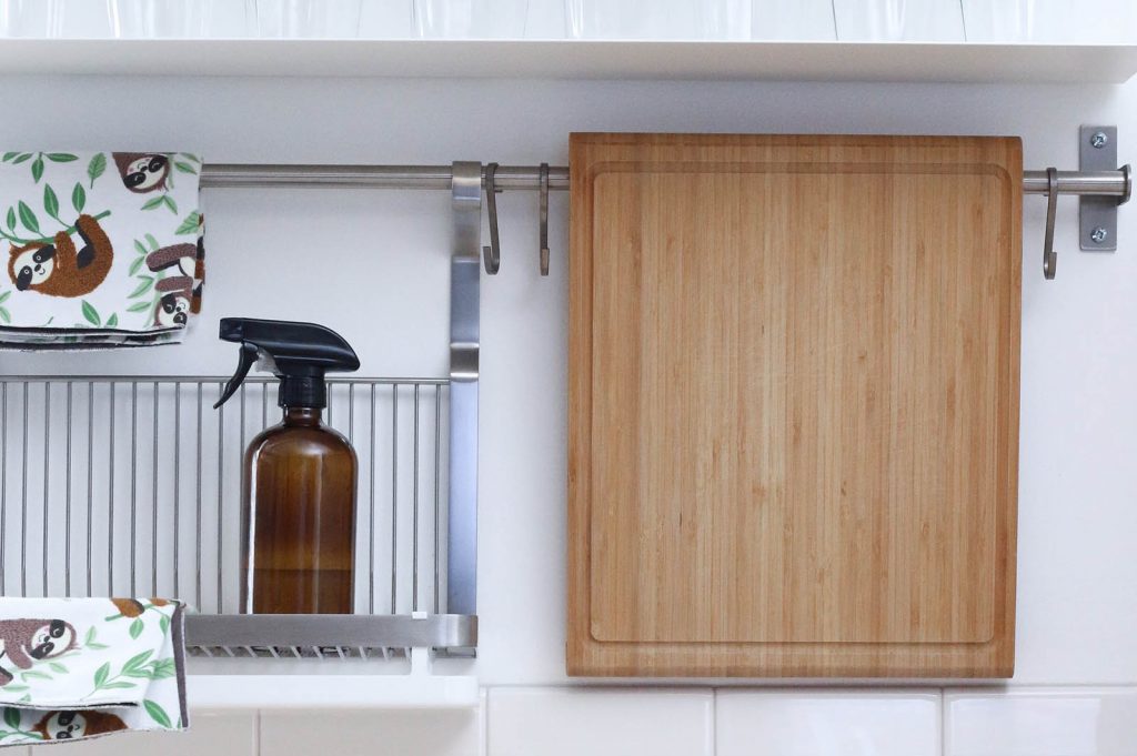 A tidy cleaning area with a spray bottle and cute towels