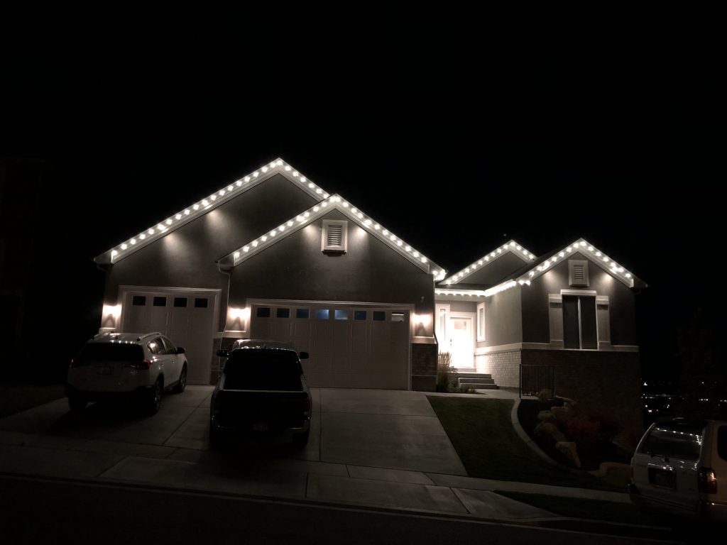 An evenly lit home with white Christmas lights