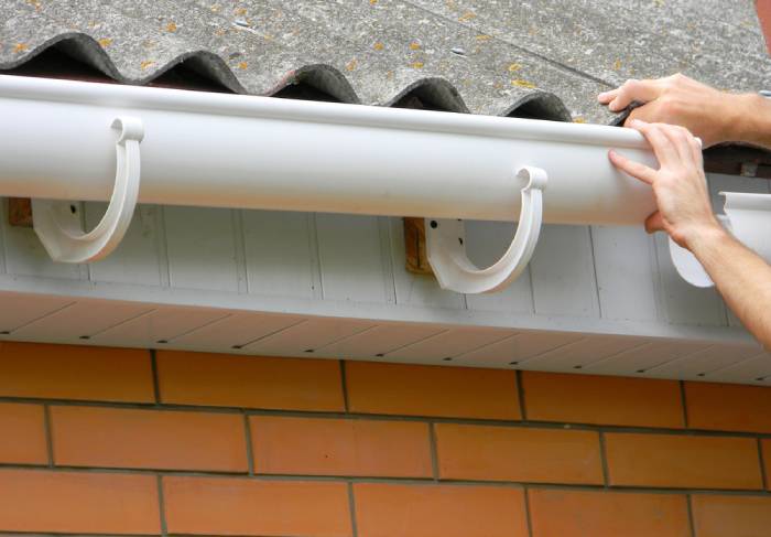 A closeup of a gutter being properly inspected