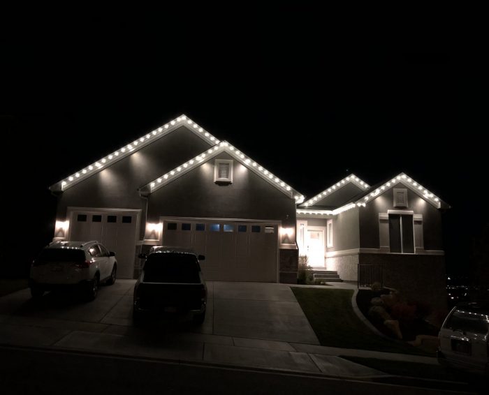 An evenly lit home with white Christmas lights